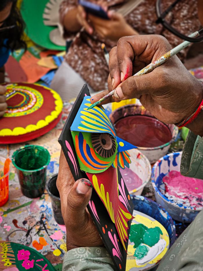 Close-up of a vibrant hand-painting craft activity showcasing colorful designs.